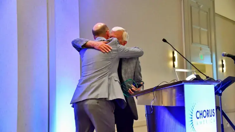 John Alexander hugging award giver